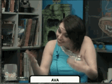 a woman in a blue tank top with the name ava at the bottom of the screen