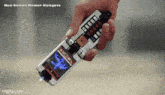 a hand is holding a neo-sabon power rangers cell phone