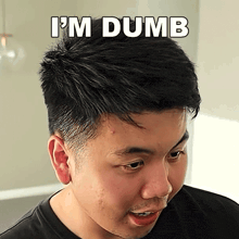 a close up of a man 's face with the words i 'm dumb below it