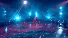 a man is holding a woman in his arms on a stage