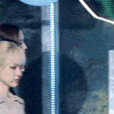 a blurry photo of two women standing next to each other in front of a window