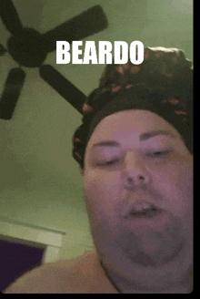 a man with a hat on has the word beardo on his head
