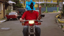 a man in a red shirt is riding a honda motorcycle on a street