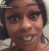 a close up of a woman 's face with a surprised look on her face and her mouth open .