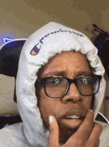 a person wearing glasses and a hoodie that says champion on it