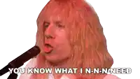 a man singing into a microphone with the words you know what i n-n-n-need below him