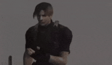 a man in a black shirt is riding an exercise bike in a dark room .