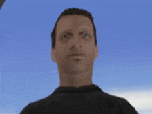 a man in a black shirt is looking at the camera with a blue sky in the background