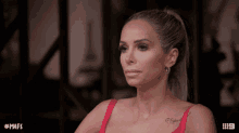 a woman with a tattoo on her chest looks at the camera with the hashtag # mafs