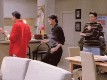 a man in a red shirt is dancing in front of a sign that says " keep your speed down "