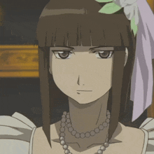 a woman with a flower in her hair and a necklace