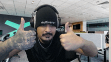 a man wearing headphones and a beanie with the word multivers on it