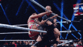 two women are wrestling in a ring and one of them is wearing a red and black outfit