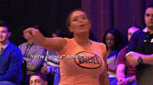 a woman wearing a shirt that says ' you 're lying a dumb f * ck '
