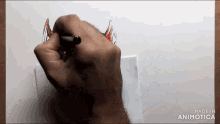 a person is drawing a dragon 's wings on a piece of paper with the words made in animotica below them