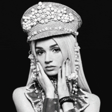 a woman wearing a hat with pearls on it