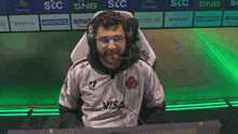 a man wearing headphones and a white shirt that says visa on it
