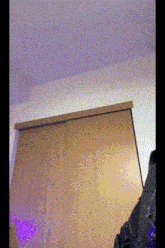 a purple light is shining on a wooden wall