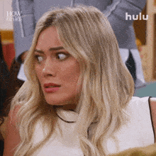 a close up of a woman 's face with the words how i met your father on the bottom