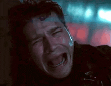 a man is crying with a tear coming out of his nose .