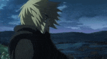 a man with blonde hair is standing in a field at night looking at something .