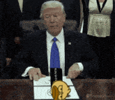 donald trump sitting at a desk with a sign that says run with it