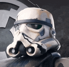 a close up of a storm trooper 's helmet with a star wars symbol in the background
