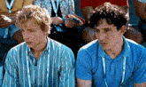 two men wearing blue shirts with a lanyard around their neck that says ' ucsd ' on it