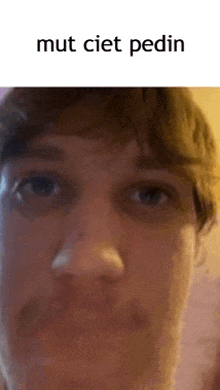 a close up of a man 's face with a nose wipe .