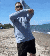 a man standing on a beach wearing a shirt that says ' tsv ' on it