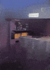 a dark room with a sign on the wall that says ticketroom