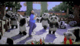 a man is dancing with panda bears in a minecraft world