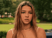 a young woman wearing a choker with the letter s on it