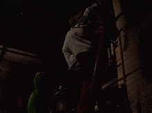 a person climbs a ladder in the dark