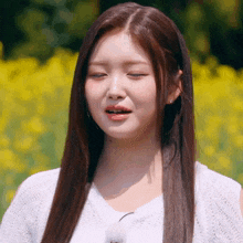 a woman with long hair is wearing a white shirt