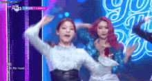 a group of young women are dancing on a stage .