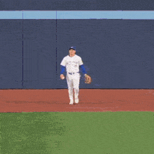a baseball player wearing a white jersey with the name tate on the back