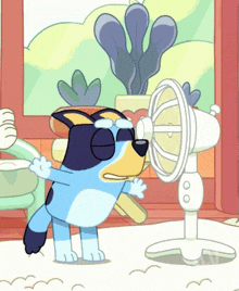 a cartoon dog wearing sunglasses is standing next to a fan