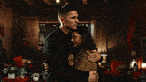 a man and woman hugging in a living room