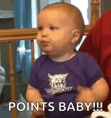 a baby wearing a purple shirt that says weber state