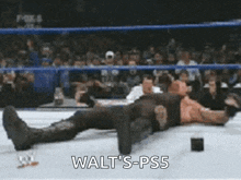 a wrestler is laying on the ground with the words walt 's-ps5 below him