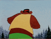 a cartoon bear with a red nose is standing in front of trees