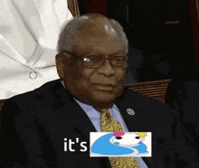 a man in a suit and tie is sitting in front of a picture that says it 's on it