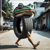 a frog is carrying a tire on its head .
