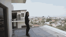 a woman standing on a balcony with the words made in animotica on the bottom right