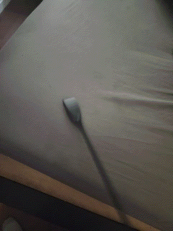a person is cleaning a bed with a brush