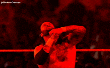 a man in a wrestling ring with his arms outstretched and the hashtag @thekamdreesen on the bottom