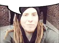 a man with dreadlocks and a beard is taking a selfie with a speech bubble above his head