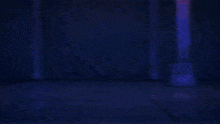 a man in a blue hoodie is holding a sword in front of a superhero
