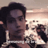a blurry picture of a man 's face with the words heeseung de brisa on it